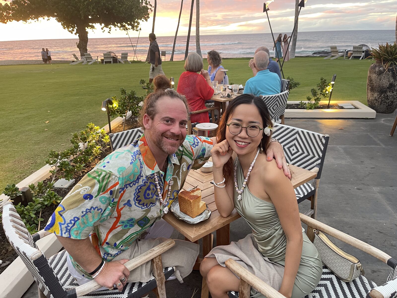 Couple at an oceanfront sunset dinner on the Kona coast
