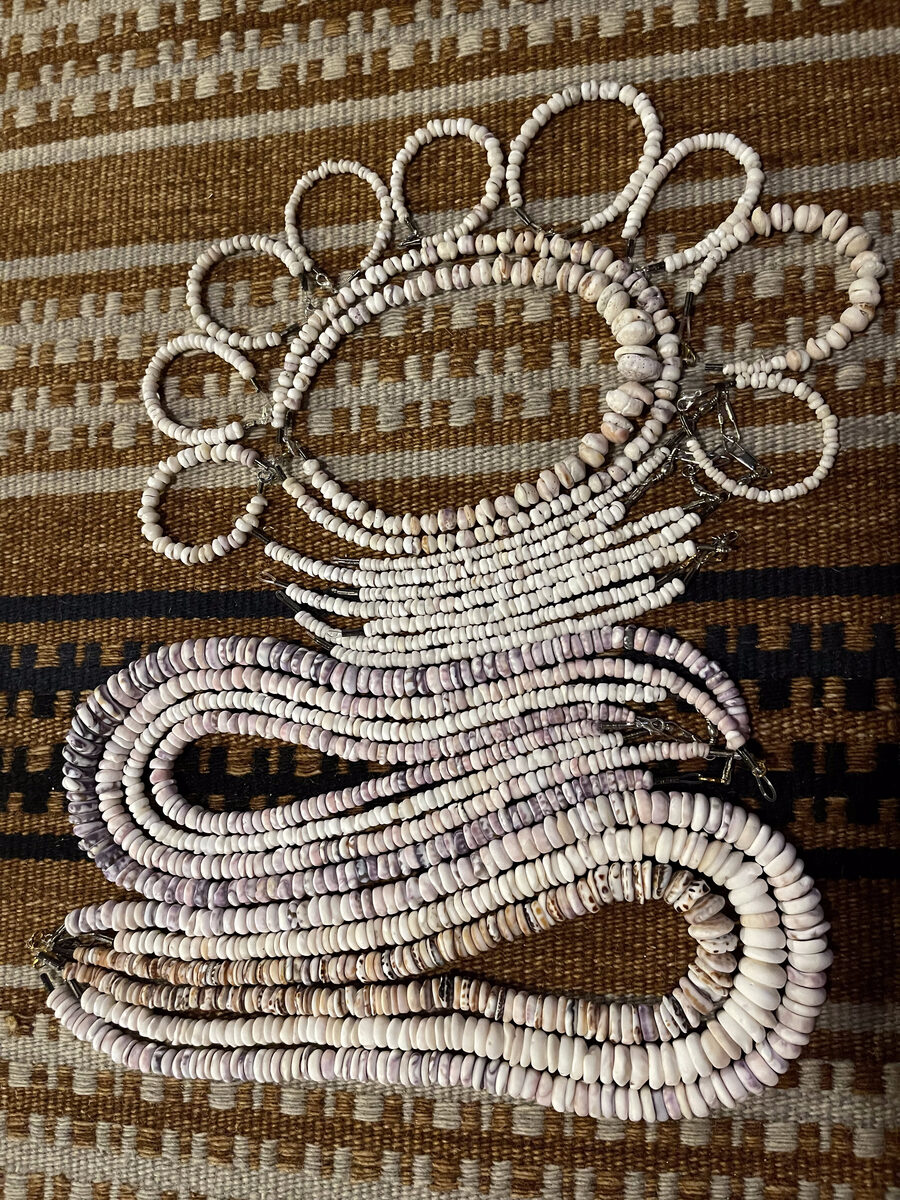 Wearable shell art handcrafted from white Hawaiian shells, an early Holo Holo Bolo creation