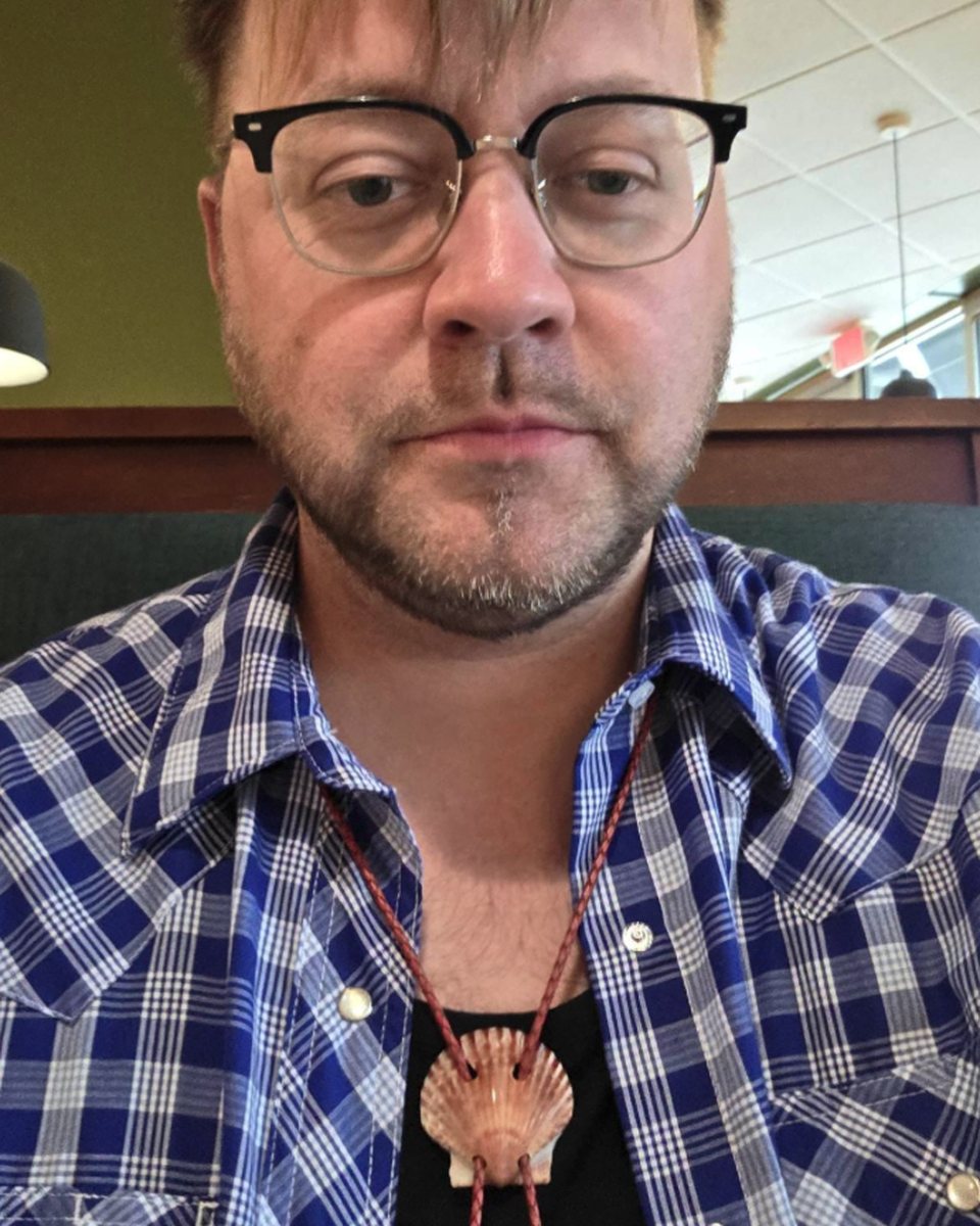 ‘Love Look’ Scallop shell bolo tie worn by its keeper over a blue plaid western shirt